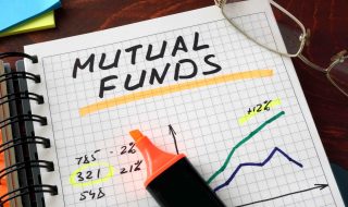 Notebook with mutual funds  sign on a table. Business concept.