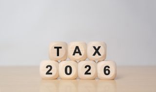 TAX in 2026 concept, on wooden block. State taxes,tax payment, governant ,calculating finance, tax accounting, statistics and data analytic reserach, calculation tax return, strategy plan, report