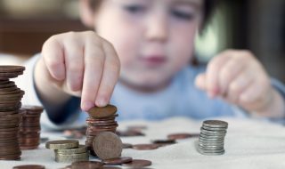 A young boy counting his piggy bank money