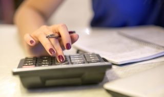Close up of female accountant or banker making calculations