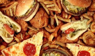 Fast food items like hot dogs, hamburgers, fries and pizza